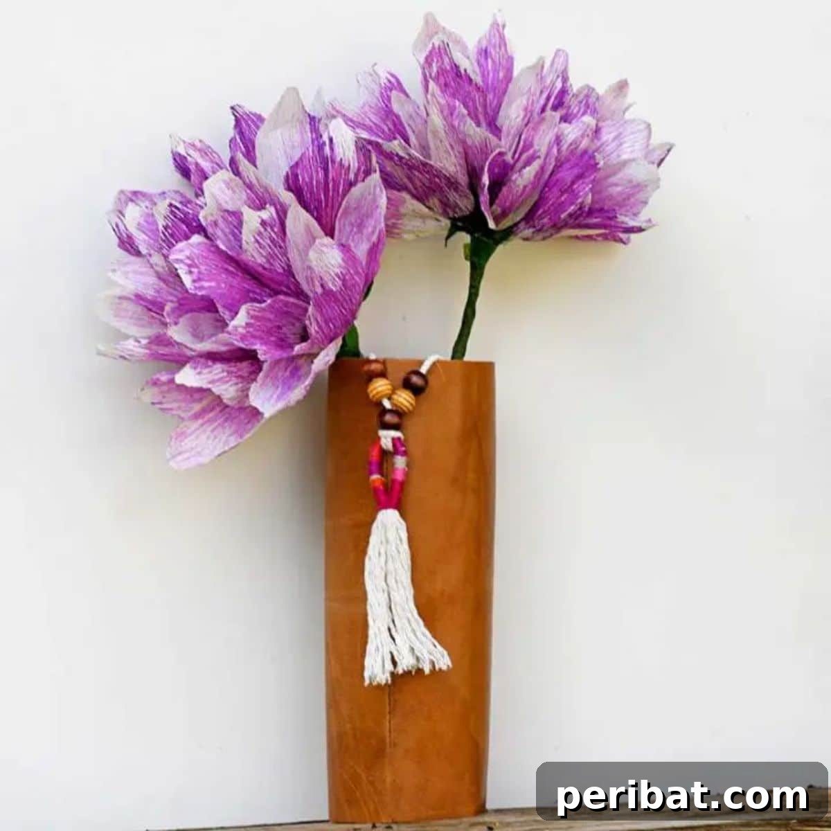 120 Inspiring DIY Boho Decor Ideas and Projects 52 Eco-friendly three-in-one upcycled leather boho DIY vase, tassel, and floral arrangement, adding bohemian vibe.