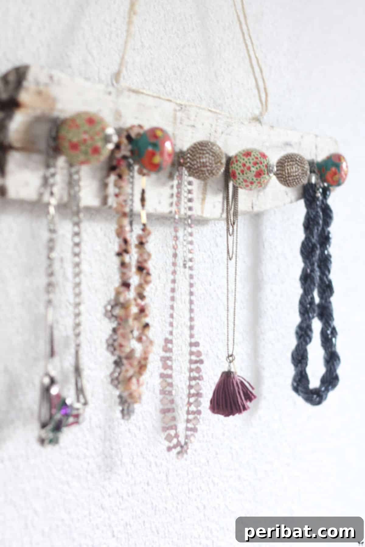 120 Inspiring DIY Boho Decor Ideas and Projects 85 Functional and stylish Jewels Boho Hanger, transforming a plank and fancy handles into an appealing necklace organizer.