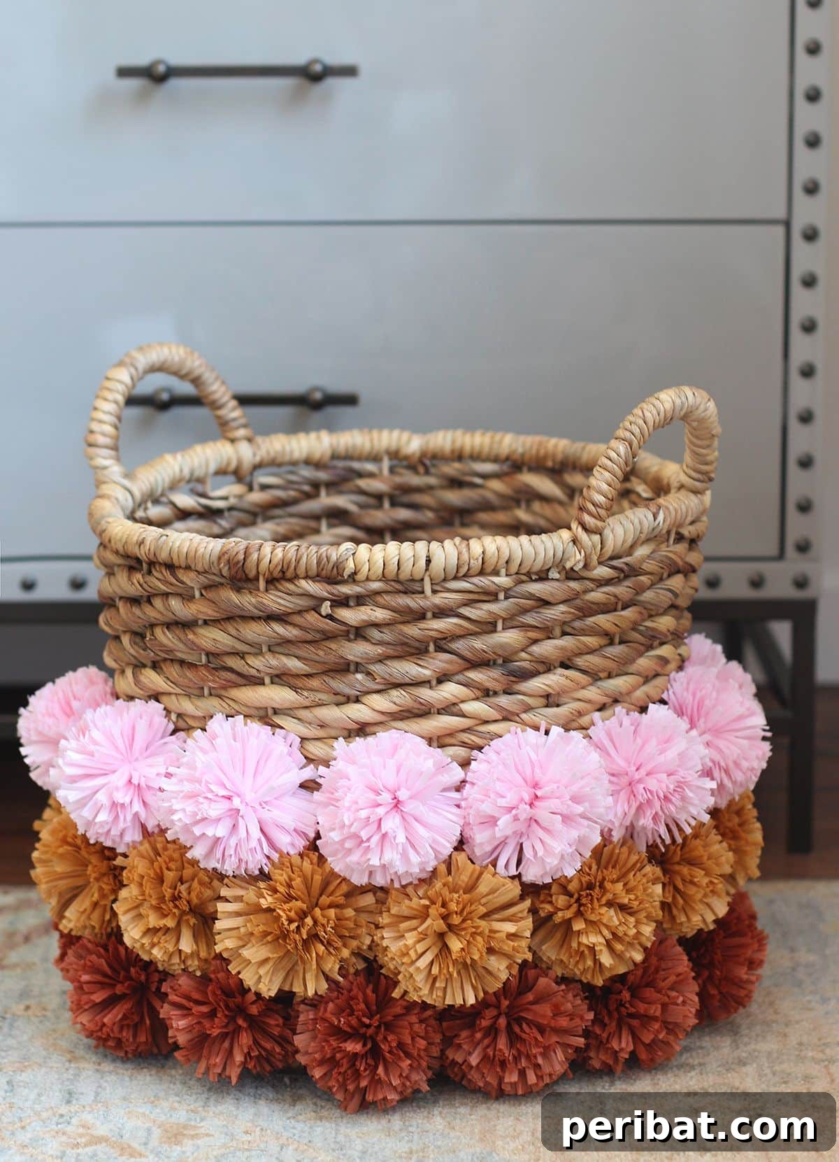 120 Inspiring DIY Boho Decor Ideas and Projects 88 Charming DIY pom-pom basket, adorned with raffia poms, injecting playful spirit and practical storage into home decor.