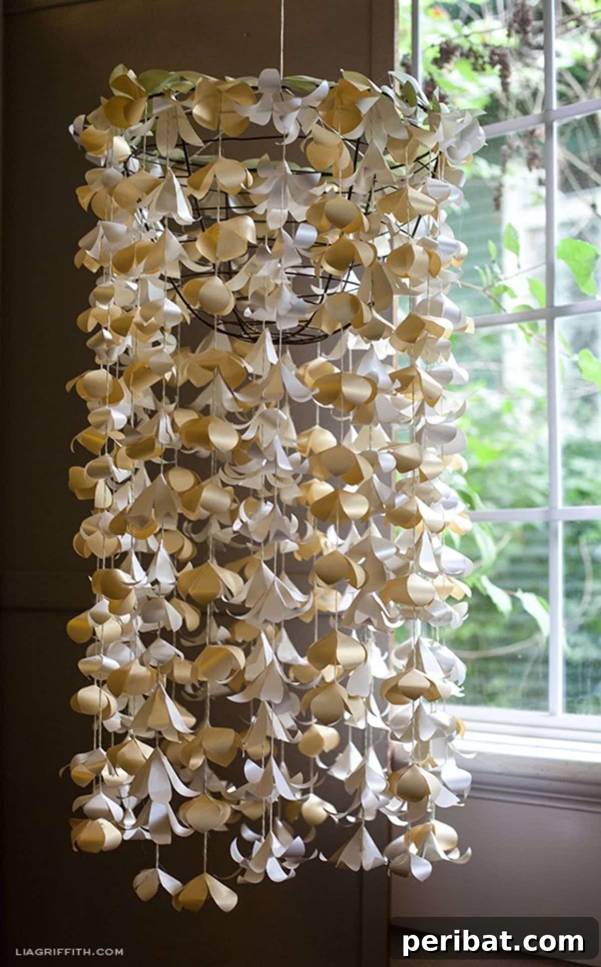 DIY paper flower chandelier for a whimsical and feminine birthday party atmosphere