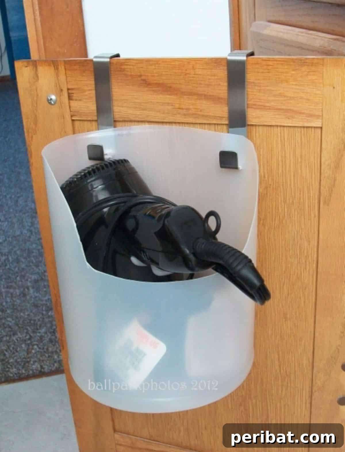 DIY Plastic Milk Jug Caddy for conveniently tucking away hair dryers, straighteners, pans, and chopping boards, reducing disorganization.