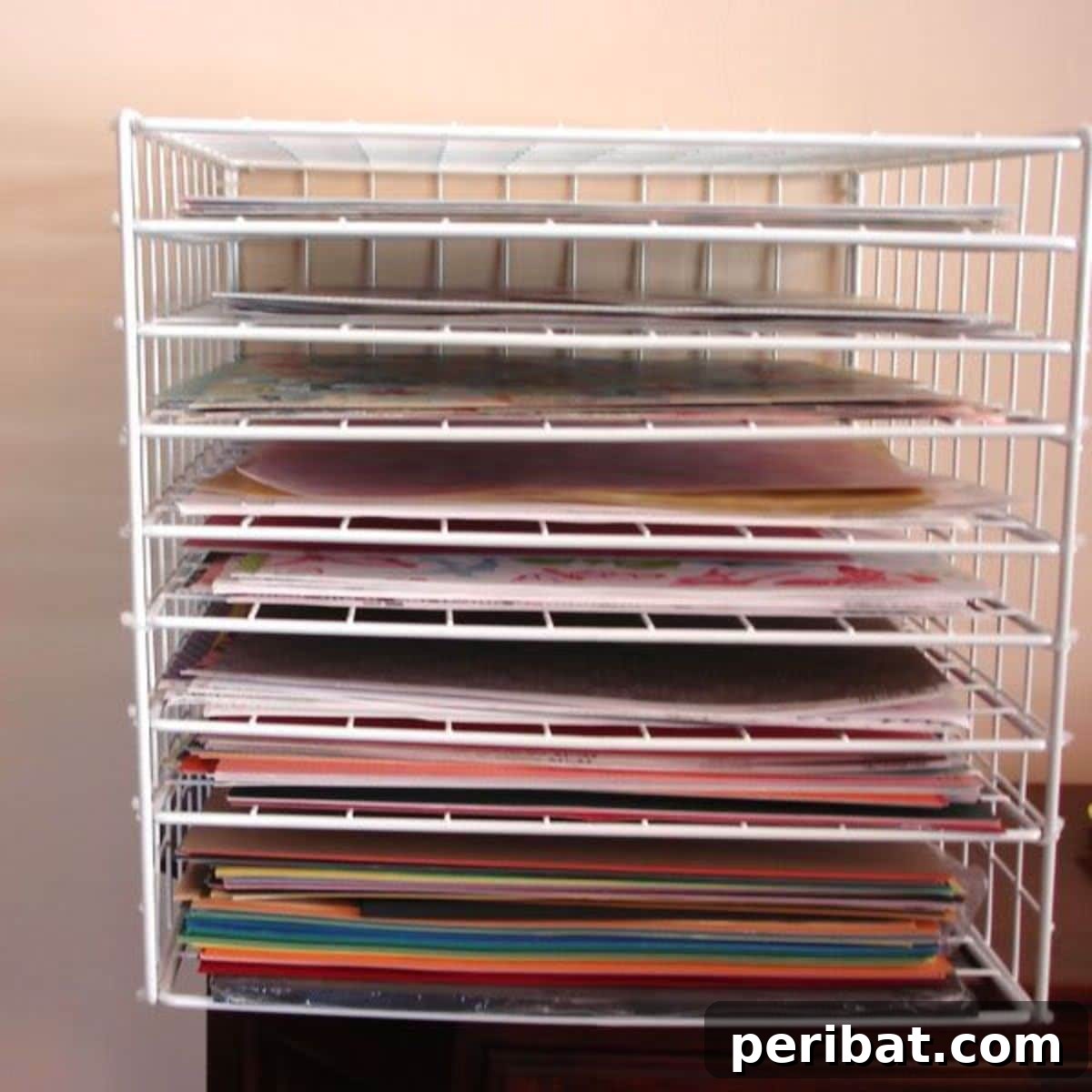 DIY paper storage rack made from wire grids for scrapbook paper.
