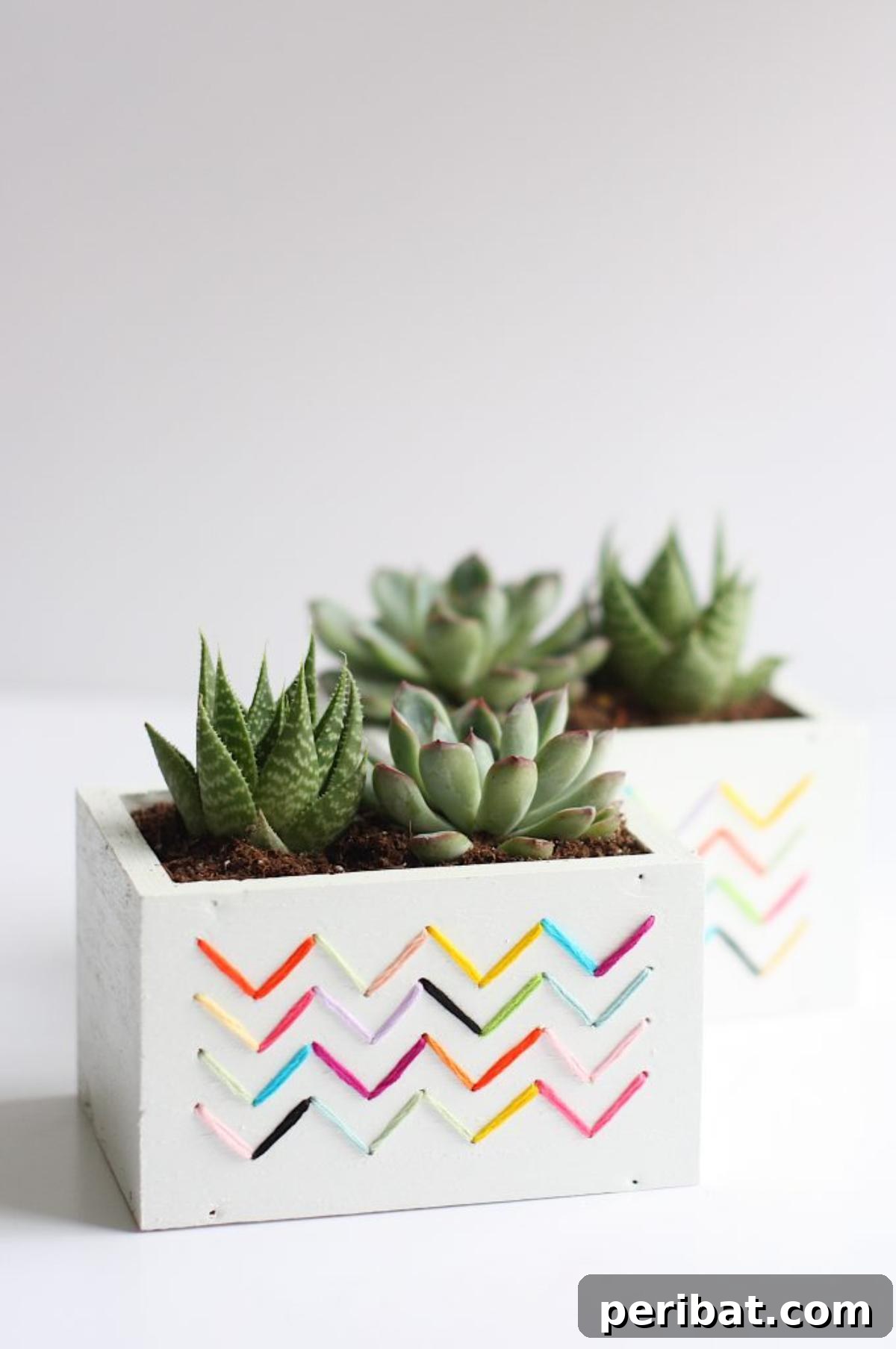 50 Plant Display Ideas: DIY Projects and Product Picks 38 Terra cotta planters adorned with vibrant embroidered patterns