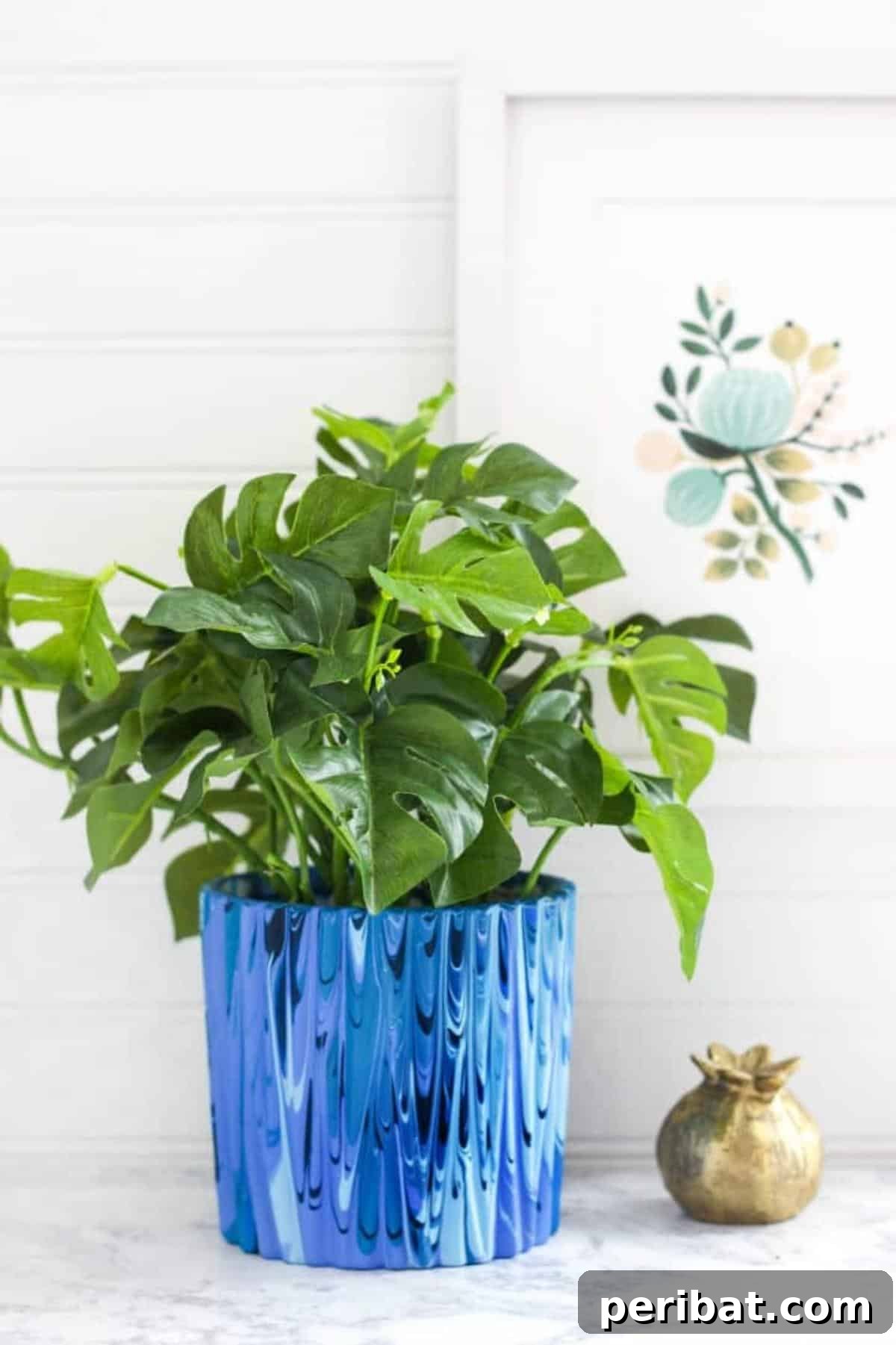 50 Plant Display Ideas: DIY Projects and Product Picks 9 Artistic poured paint planter with a vibrant dripping effect