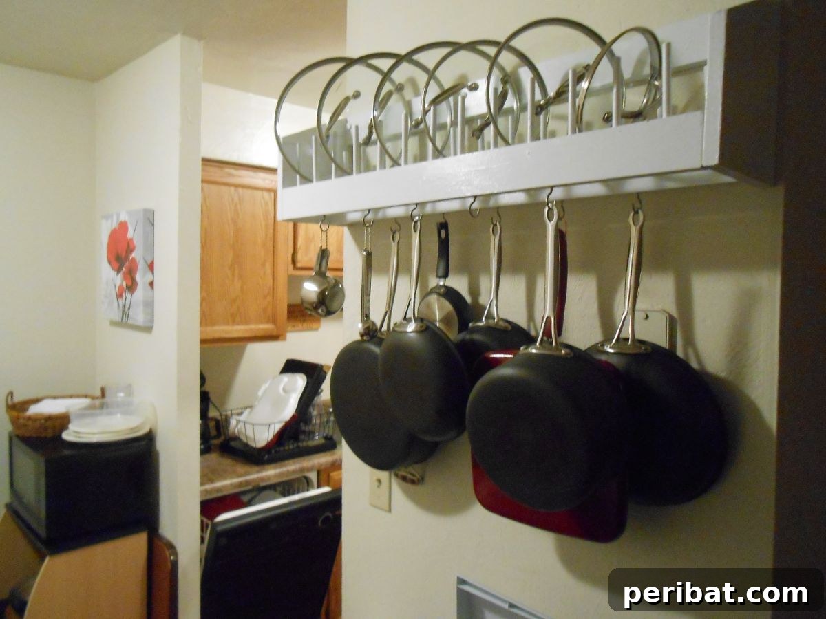 43 Brilliant DIY Pot Rack Projects 40 Organized DIY pot rack with integrated lid storage for kitchen efficiency.
