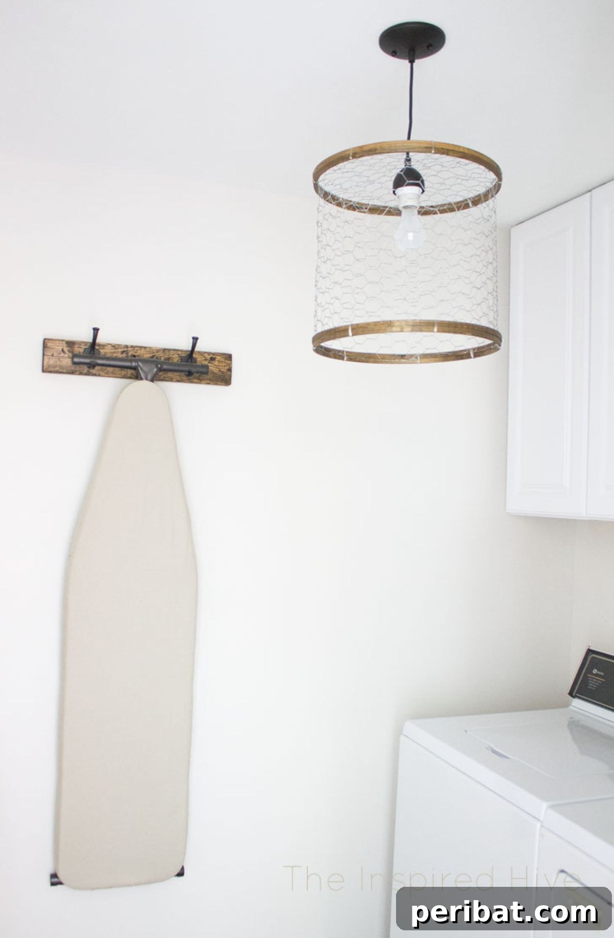 Rustic DIY chicken wire light fixture with embroidery hoops.
