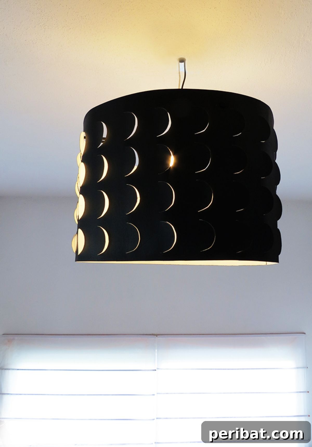 Cost-effective and eco-friendly DIY paper lampshade for artistic indoor lighting.