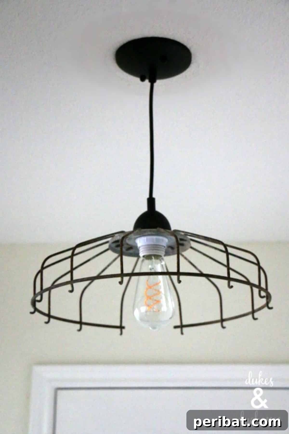 Distinctive DIY upcycled fan cover light fixture adds rustic charm.