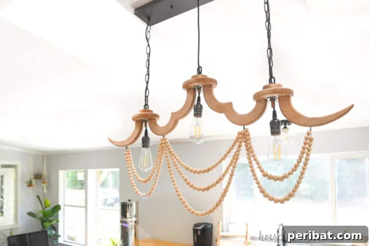 Striking DIY linear wood chandelier with wood beads for elegant indoor lighting.