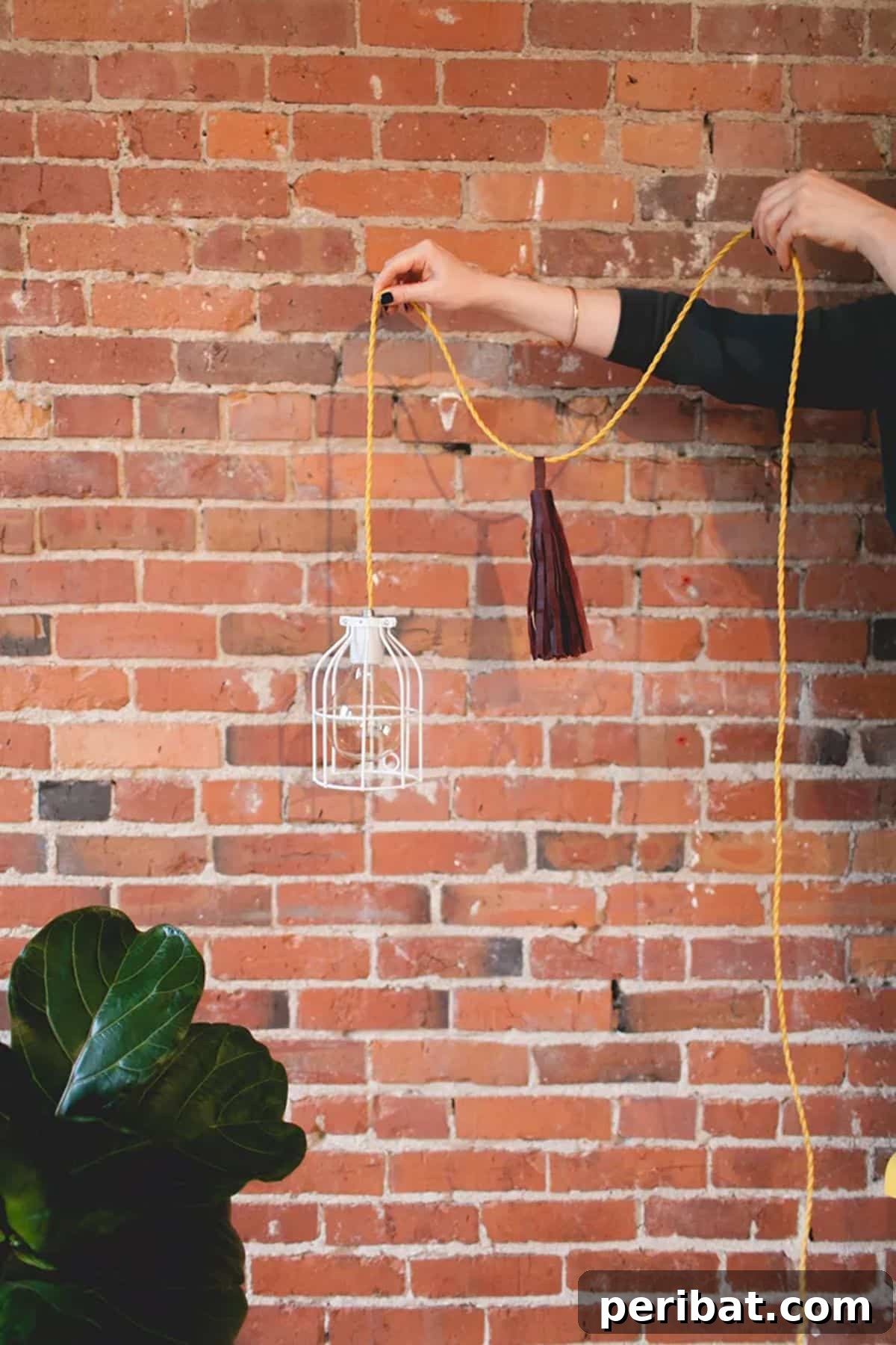 Boho-inspired DIY pendant light with leather tassel, a unique indoor lighting feature.