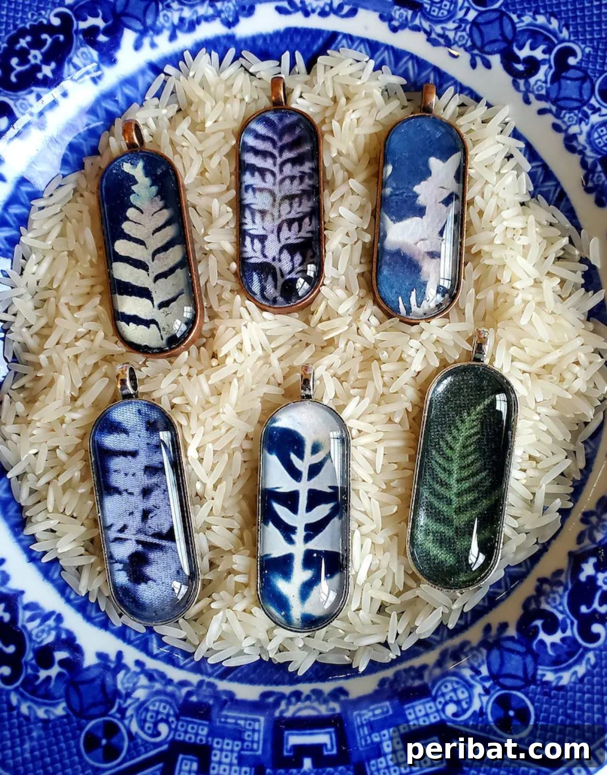Solar Artistry: 20 DIY Printmaking Ideas 10 Cyanotype Pendant, a unique handmade jewelry piece with a blue botanical design.