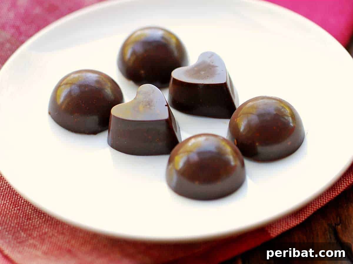 25 Delicious DIY Chocolate Kit Projects 15 Luxuriously rich homemade chocolate, possibly with nuts or other inclusions, in a silicone mold.