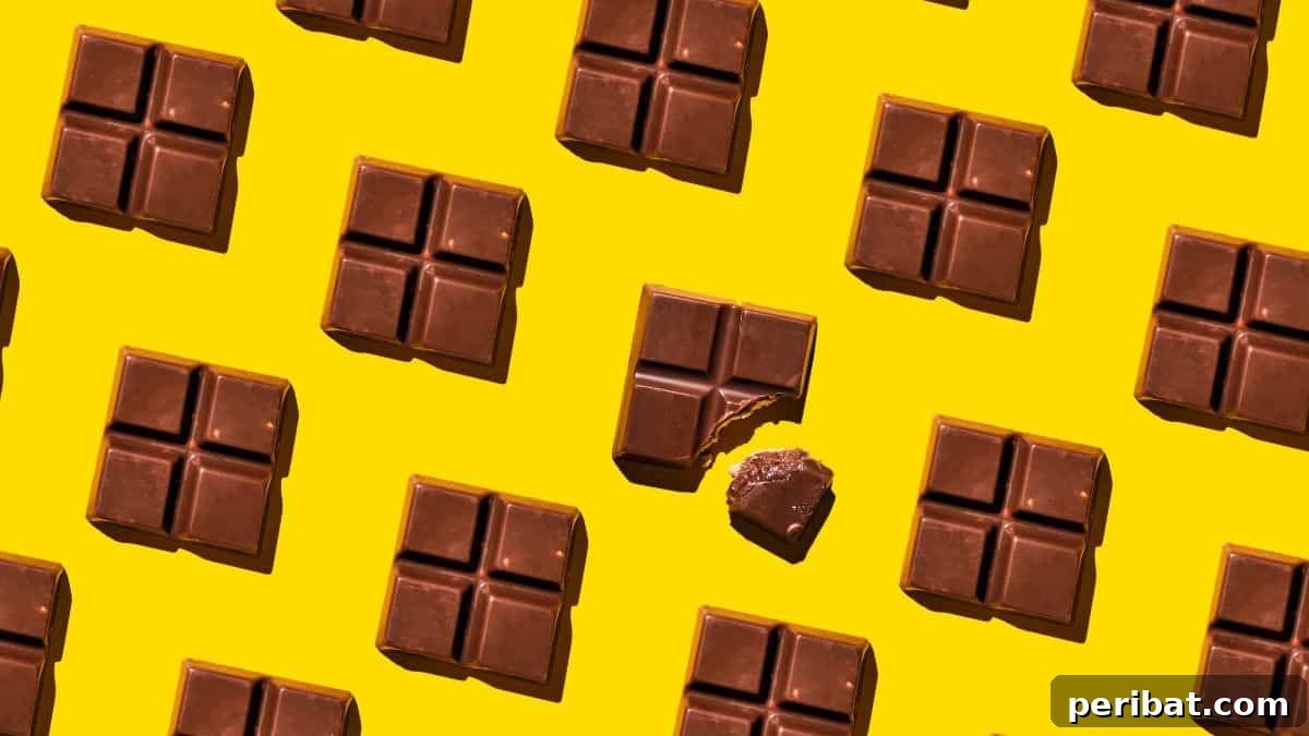 25 Delicious DIY Chocolate Kit Projects 22 A handcrafted chocolate bar next to roasted cacao beans, representing the bean-to-bar process.