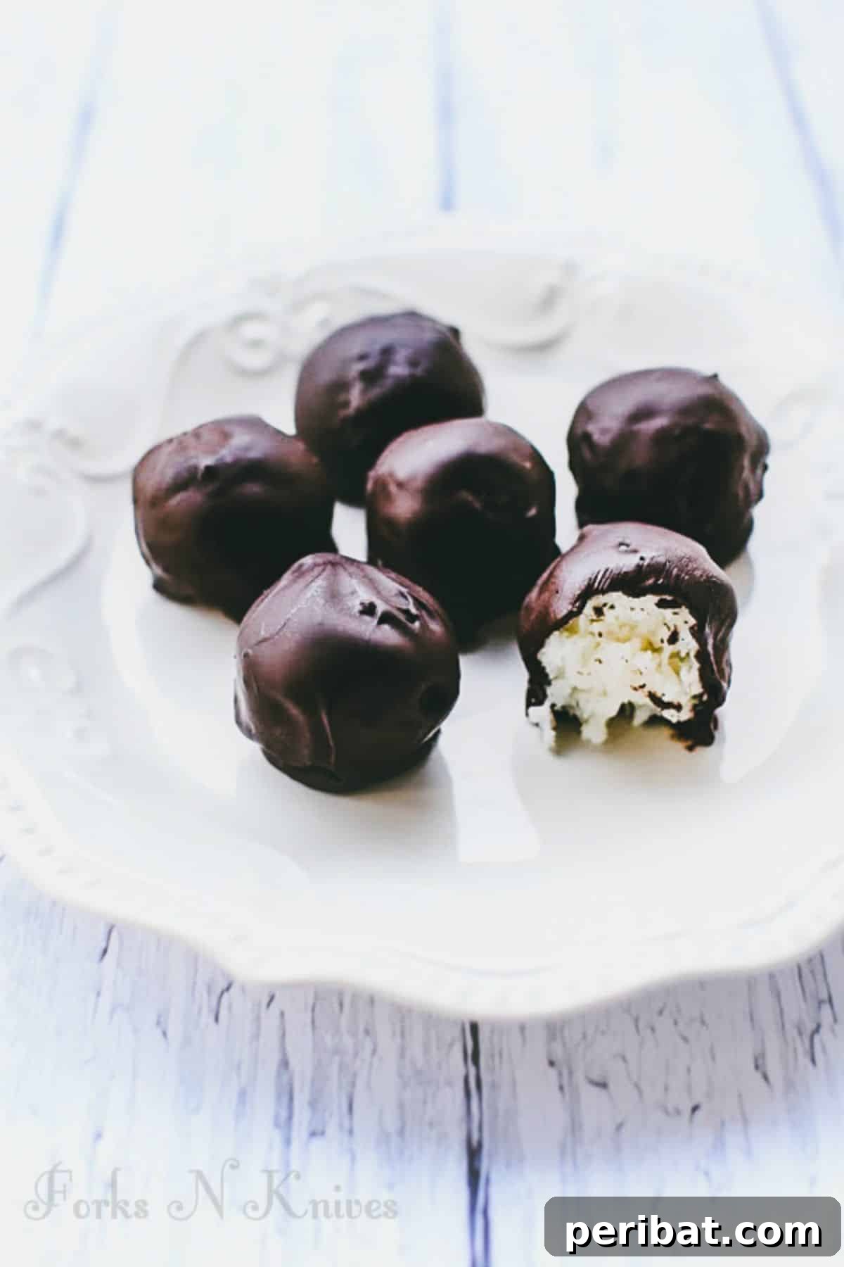 25 Delicious DIY Chocolate Kit Projects 4 Delicious homemade chocolate coconut balls arranged on a serving plate.