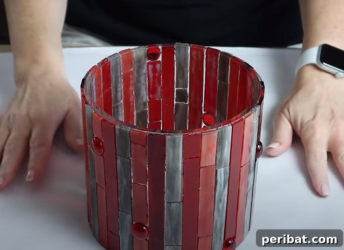 Stained glass hurricane lamp vase in gray and red, an ideal DIY project for learning glass-on-glass mosaic techniques.