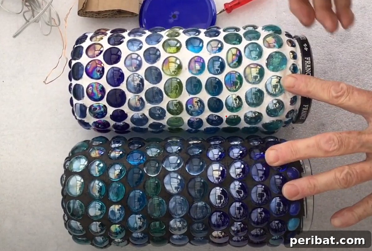 Two vibrant glass mosaic solar lamps, a simple yet charming DIY project for brightening outdoor spaces with recycled materials.