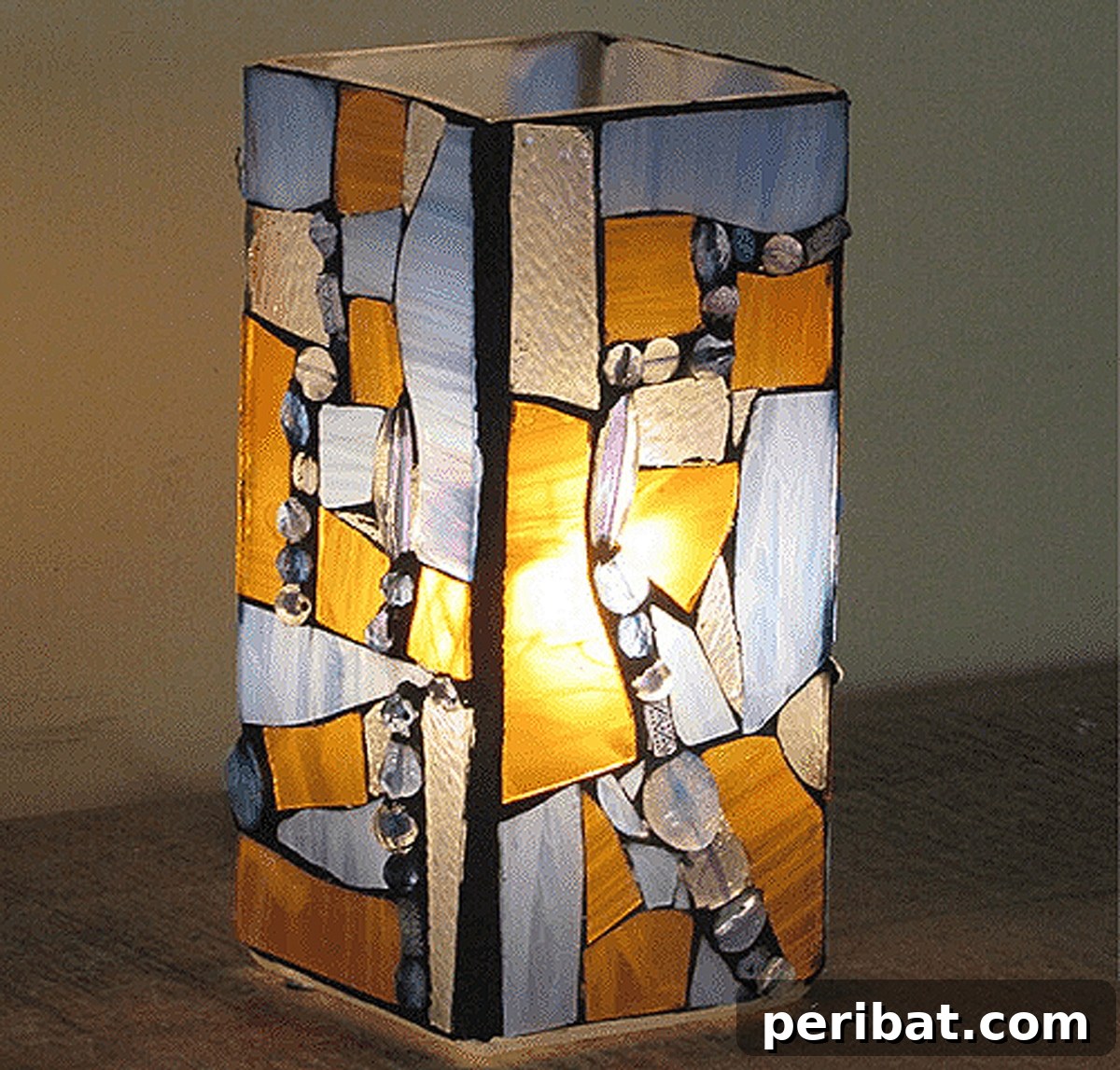 Elegant amber and sky blue mosaic lamp, transformed from an ordinary lamp into a beautifully lit artistic piece.