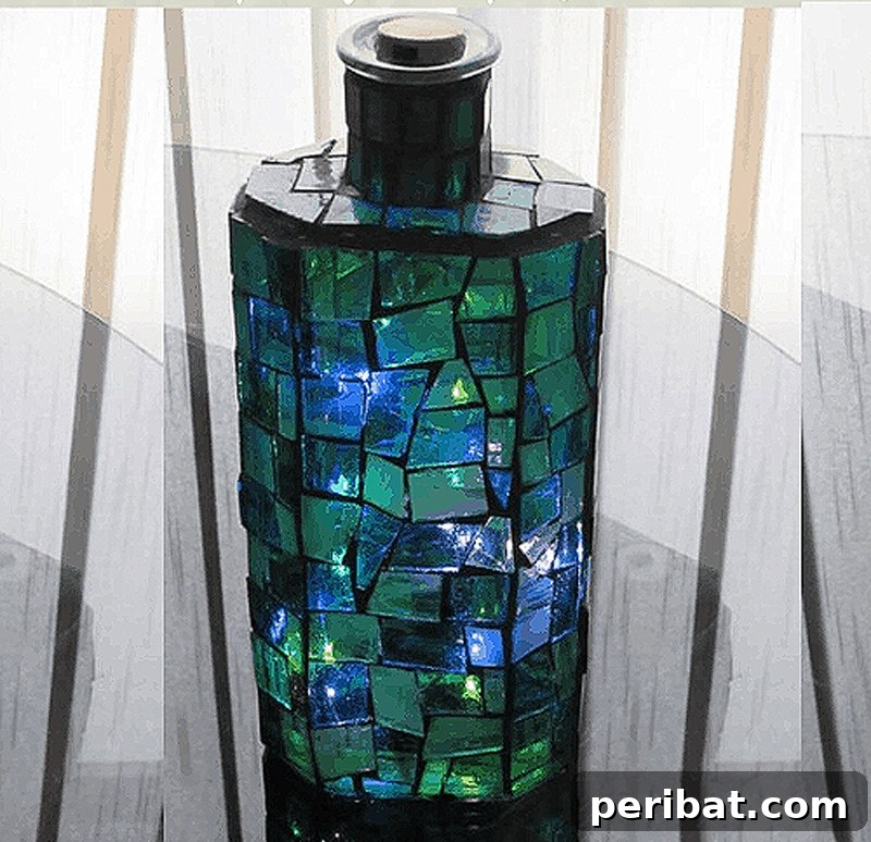 Emerald green mosaic bottle light, an exquisite upcycled ambient light source created with a DIY project.