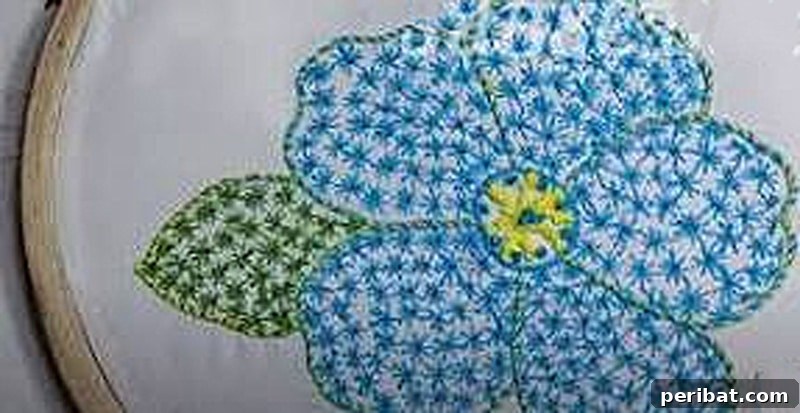 Creative DIY Floral Embroidery Ideas and Projects 17 Exquisite 3D flower design in blue embroidery, showcasing texture and dimension