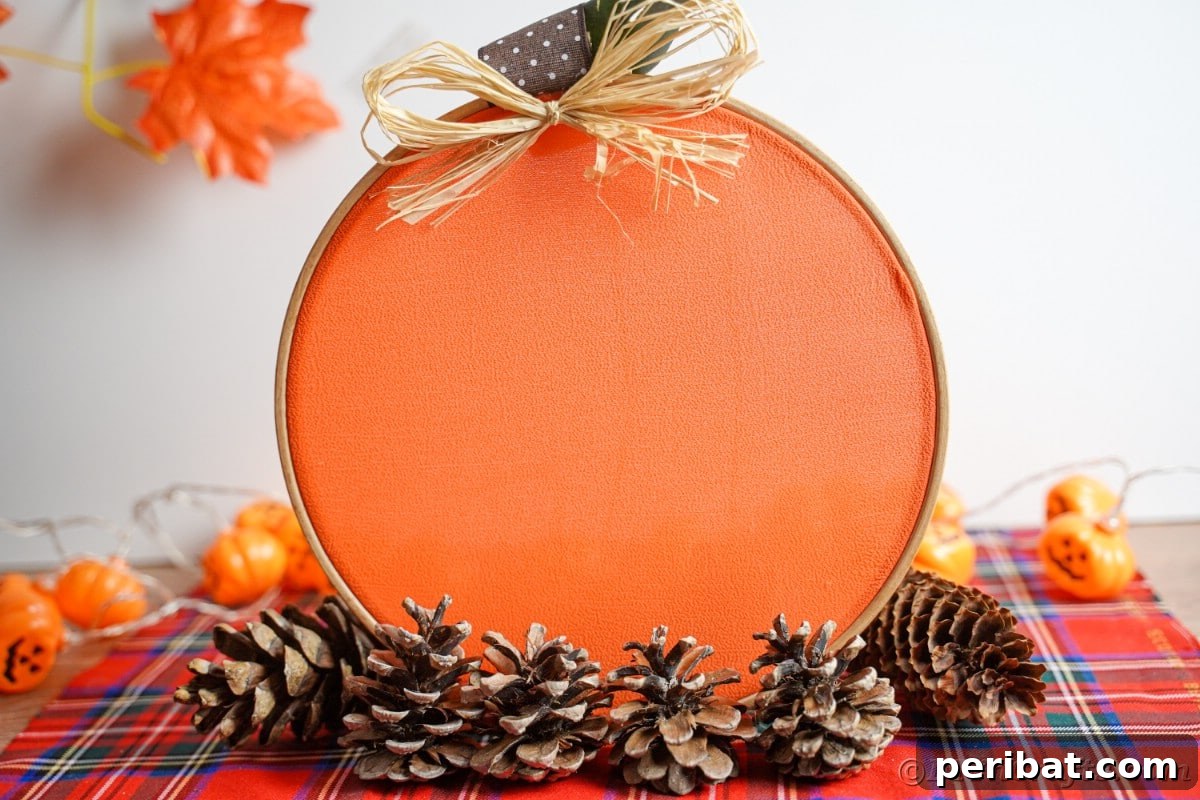 Creative DIY Floral Embroidery Ideas and Projects 3 Festive embroidery hoop pumpkin decoration on a red plaid tablecloth, perfect for fall