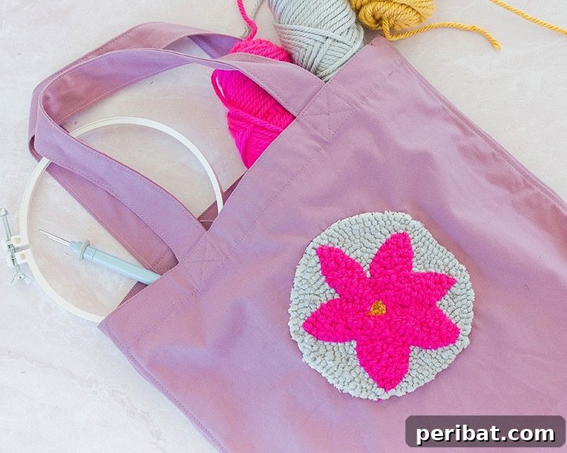 Creative DIY Floral Embroidery Ideas and Projects 38 Stylish pink floral embroidered tote bag created with punch needle, accompanied by three skeins of wool thread