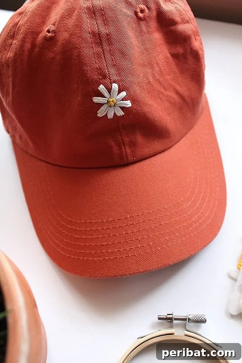 Creative DIY Floral Embroidery Ideas and Projects 40 Vibrant hand-embroidered orange hat with delicate floral stitching, showcasing a custom and unique accessory