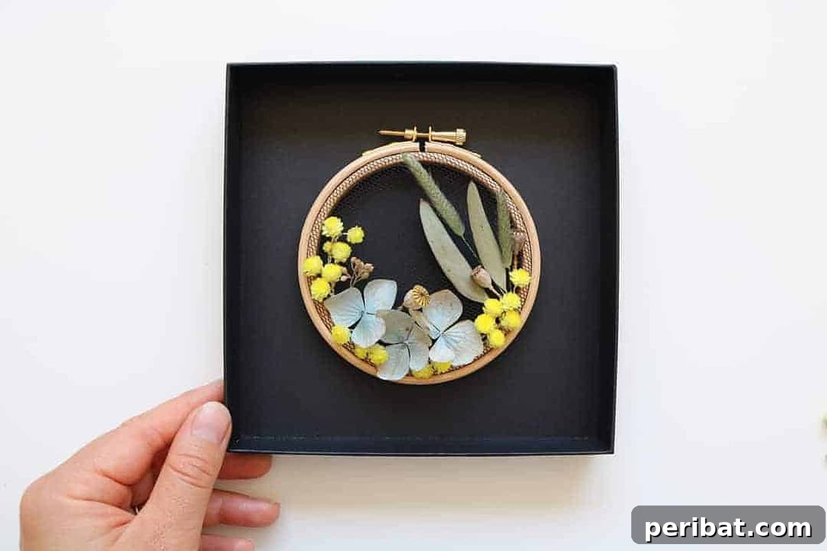 Creative DIY Floral Embroidery Ideas and Projects 41 Stunning dried flowers combined with delicate embroidery within a hoop, creating unique botanical art