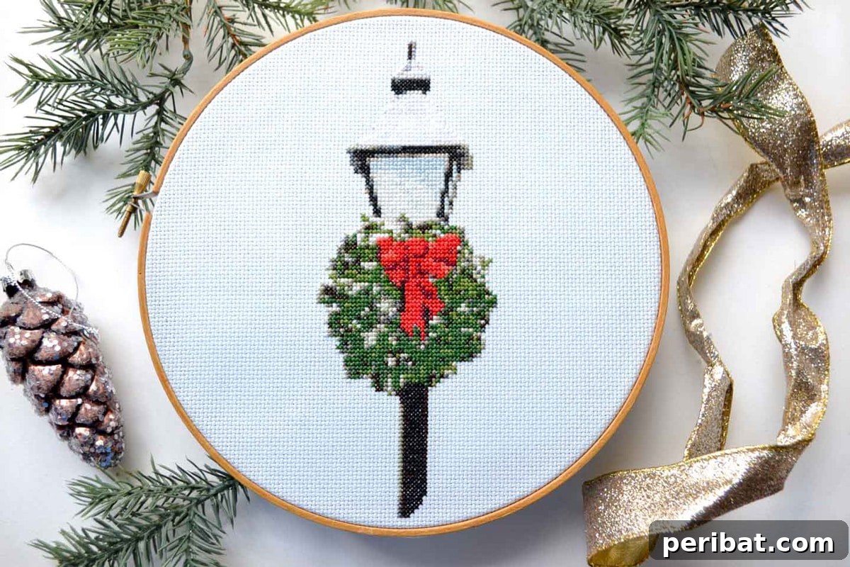 Stitch Your Way to a Merry Christmas: 48 DIY Embroidery Designs 35 A beautifully embroidered Christmas lamppost cross-stitch, perfect for traditional holiday themes.