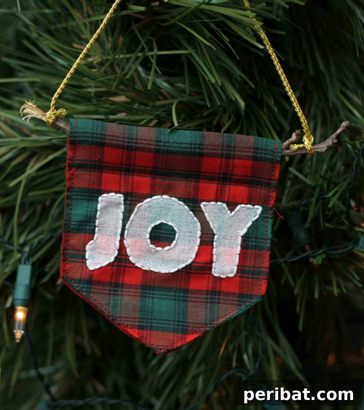 Stitch Your Way to a Merry Christmas: 48 DIY Embroidery Designs 39 Embroidered decorative flags hanging on a Christmas tree, forming pennant ornaments.