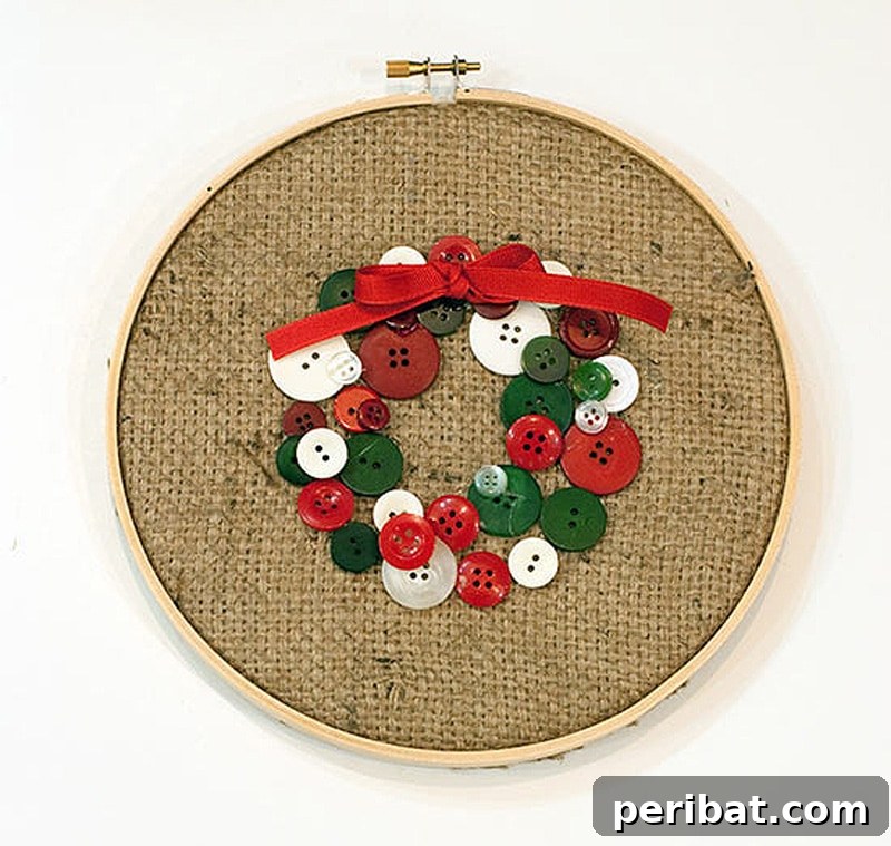 Stitch Your Way to a Merry Christmas: 48 DIY Embroidery Designs 48 A quaint Christmas wreath crafted from buttons and burlap, displayed as embroidery hoop art.