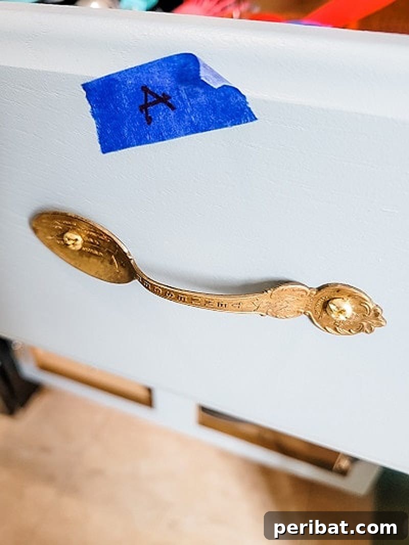 Creative door knobs made from repurposed antique spoons, bent into unique shapes.