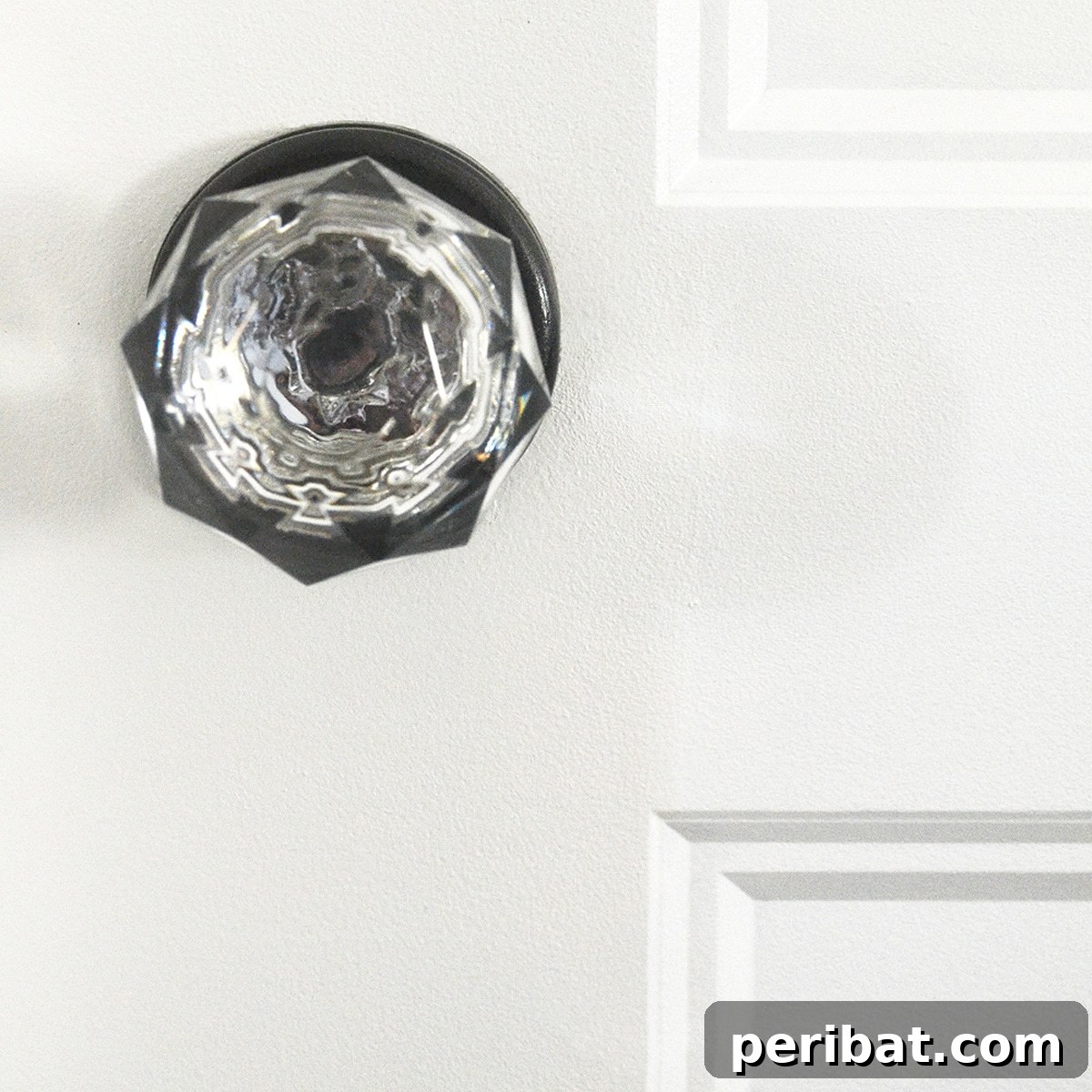 A glass door knob before and after spray painting for a frosted or colored effect.