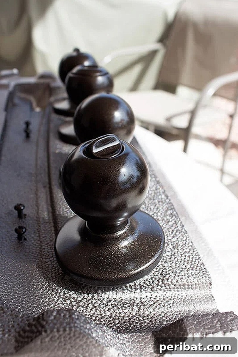 Close-up of a door knob before and after a spray paint makeover, showing a sleek black finish.