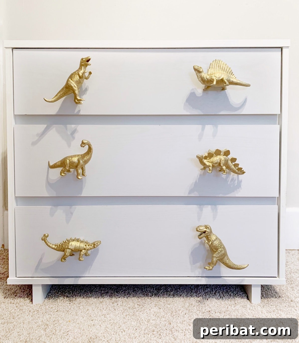 Playful dinosaur dresser knobs and pulls made from repurposed toy dinosaurs.