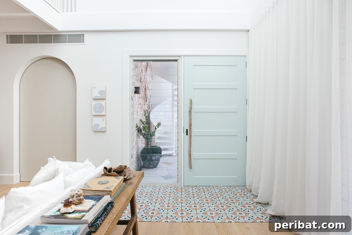 Unique driftwood door handle on a white door, embodying a coastal aesthetic.