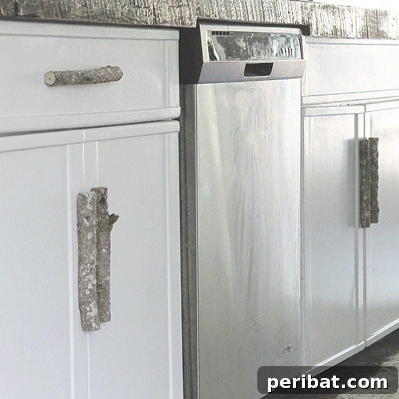 Rustic kitchen door handles made from dark metal, complementing a farmhouse style.