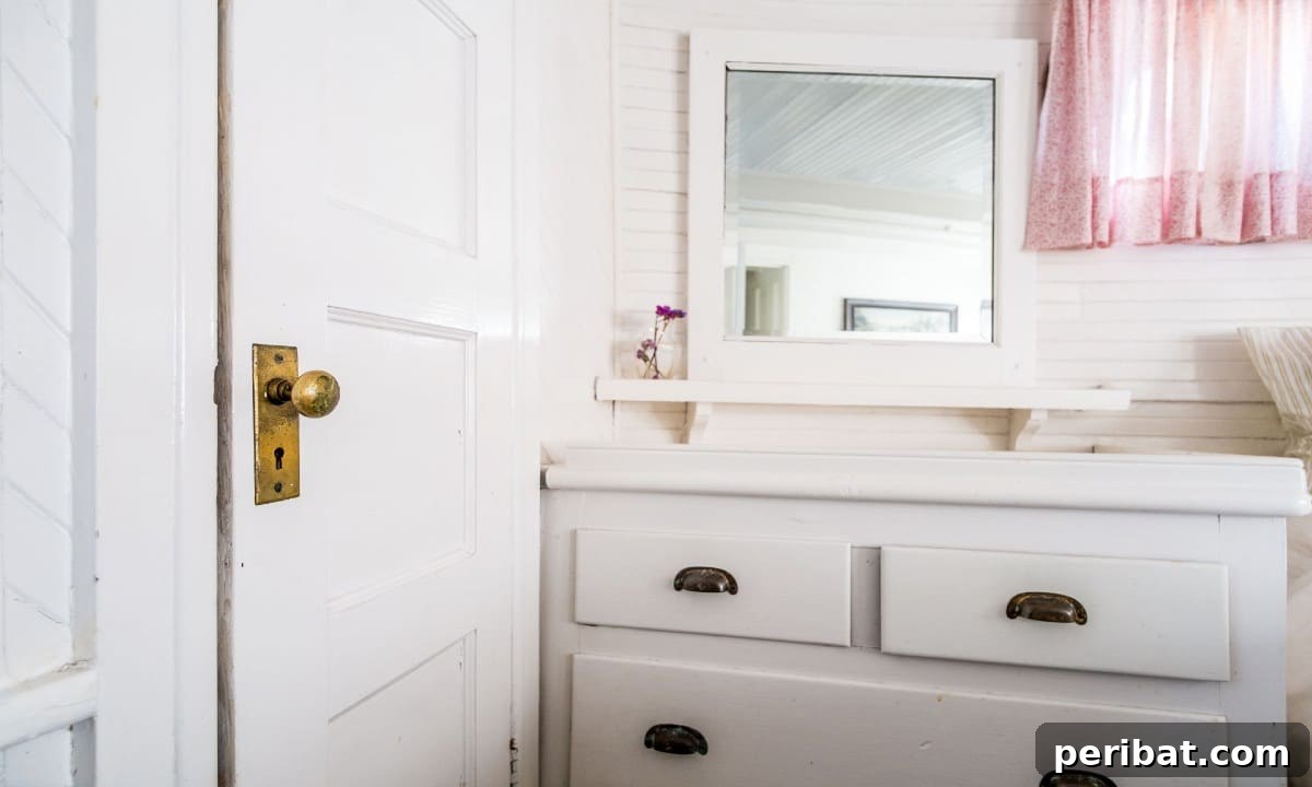 Handcrafted wooden door knob with a classic design on a bathroom door.