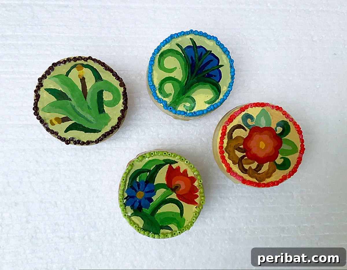 Four colorful flower-shaped knobs with intricate painted designs.
