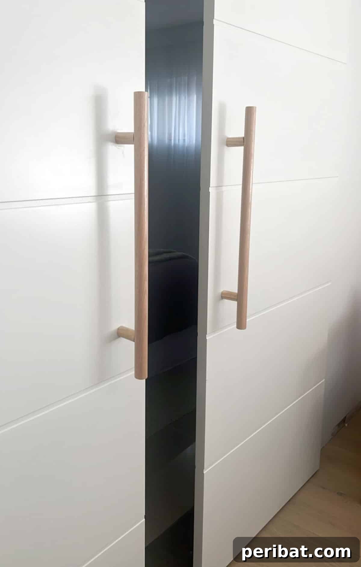 Modern timber dowel pulls and handles integrated into cabinet doors for a minimalist look.