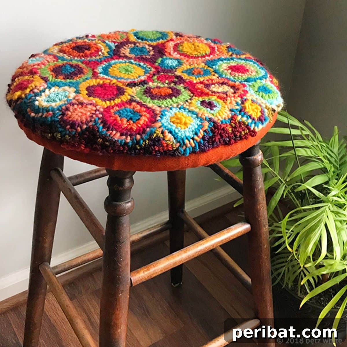 Creative DIY guide to repurposing old furniture with punch needle embroidery, like a stool cover.