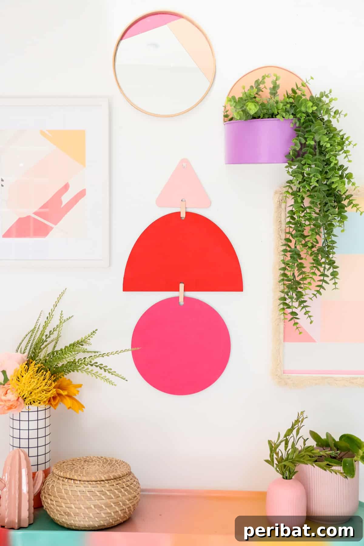 geometric wall hanging and surrounding flower pots