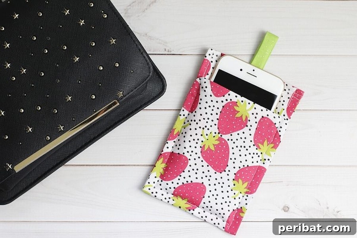 Your Phone Your Canvas 45 DIY Case Crafts 15 A charming and easy-to-make phone case, shaped like a strawberry with vibrant red fabric and green leaves, showcasing simple sewing craftsmanship.