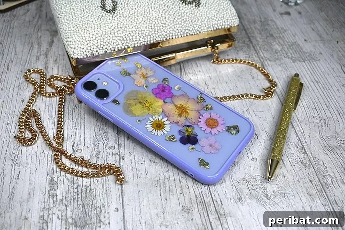 Your Phone Your Canvas 45 DIY Case Crafts 3 An elegant phone case adorned with beautifully preserved real pressed flowers, accompanied by a wallet and pen, showcasing a natural and sophisticated aesthetic.