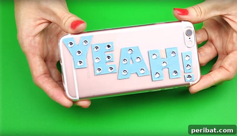 Your Phone Your Canvas 45 DIY Case Crafts 23 A charming and cute phone case, personalized with the word 'YEAH' crafted from gems and intricate cardboard detailing.