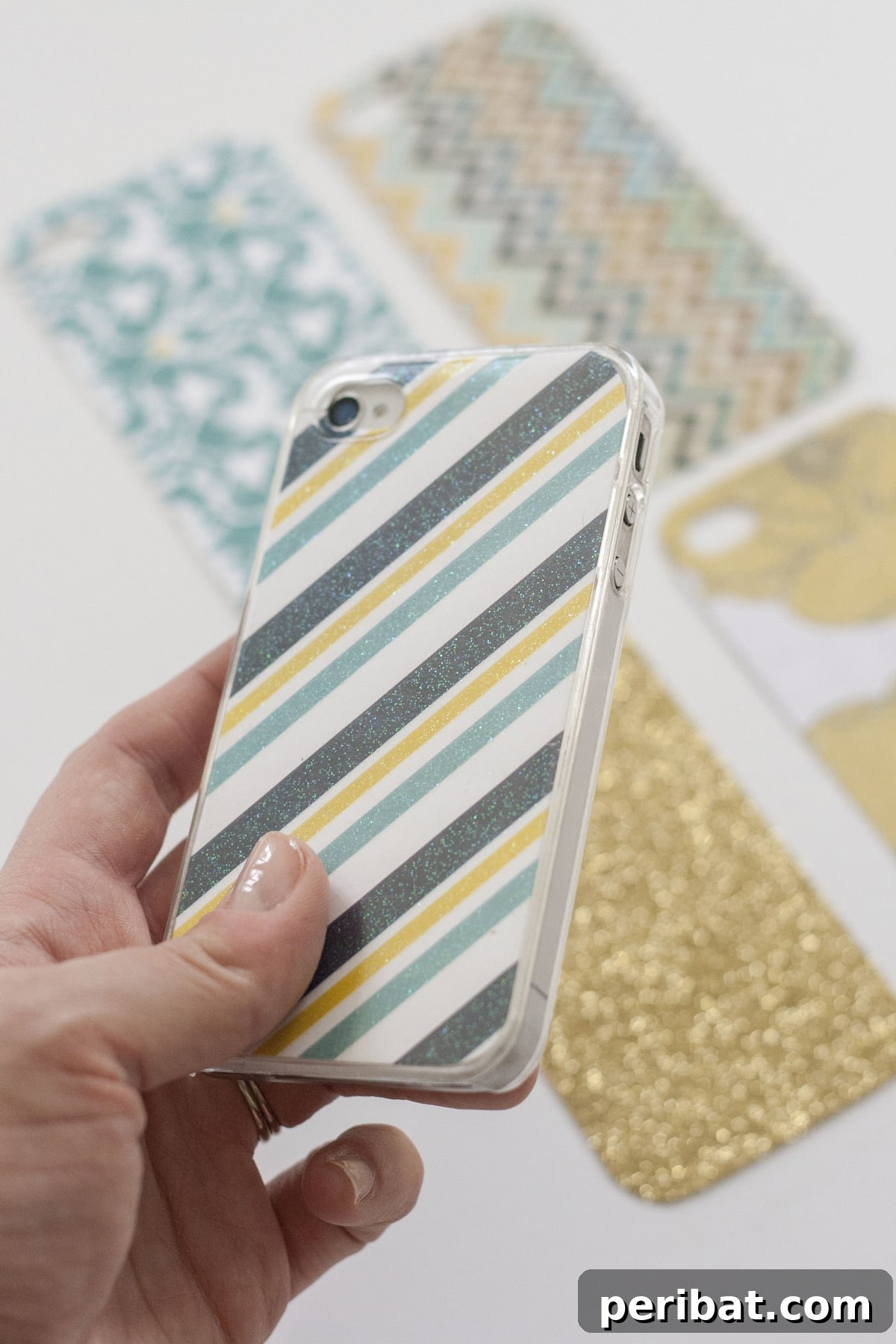 Your Phone Your Canvas 45 DIY Case Crafts 27 A hand holding a stylish phone case customized with colorful magazine clippings, creating a vibrant, eclectic mosaic design.