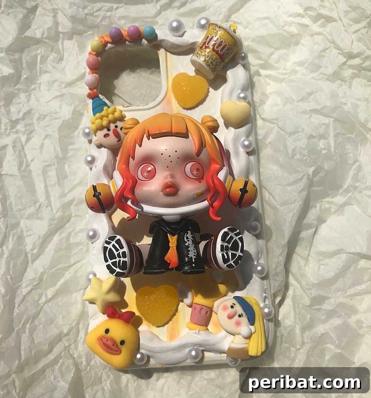 Your Phone Your Canvas 45 DIY Case Crafts 46 A cheerful Decoden phone case DIY kit starter package, featuring vibrant whipped cream textures, an array of adorable charms, and colorful sprinkles, designed for fun and whimsical customization.