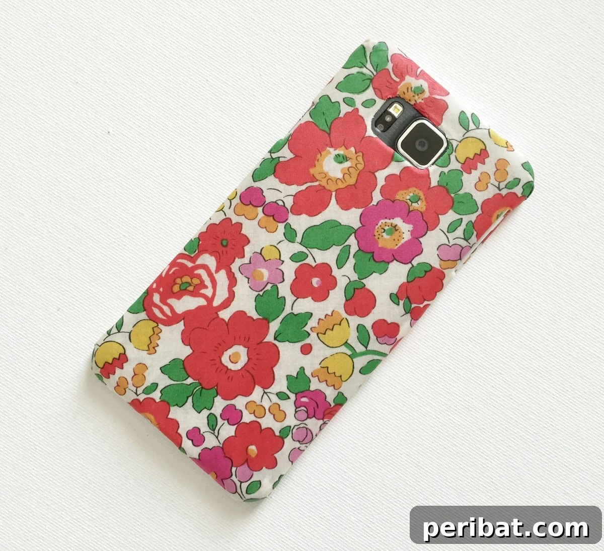 Your Phone Your Canvas 45 DIY Case Crafts 10 A stylish fabric-covered phone case, featuring a chic patterned textile applied seamlessly for a unique and tactile finish.