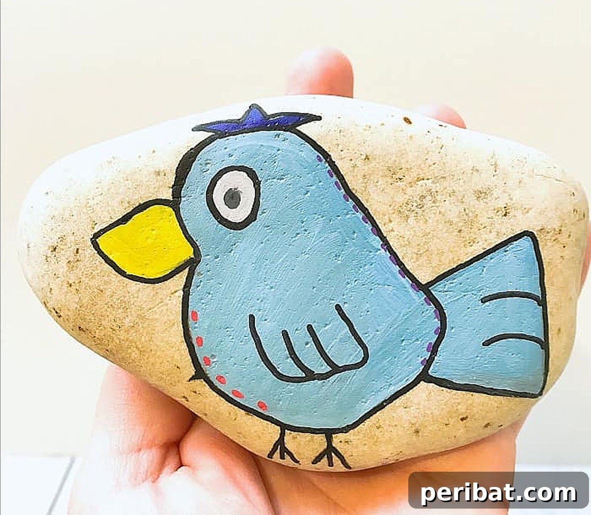 Creative Painted Rocks: Ideas, Projects, and Starter Kits 32 A charming painted bird rock, detailed and colorful