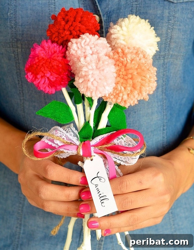A cheerful DIY Valentine's bouquet made from red and pink pom poms on sticks, resembling flowers.