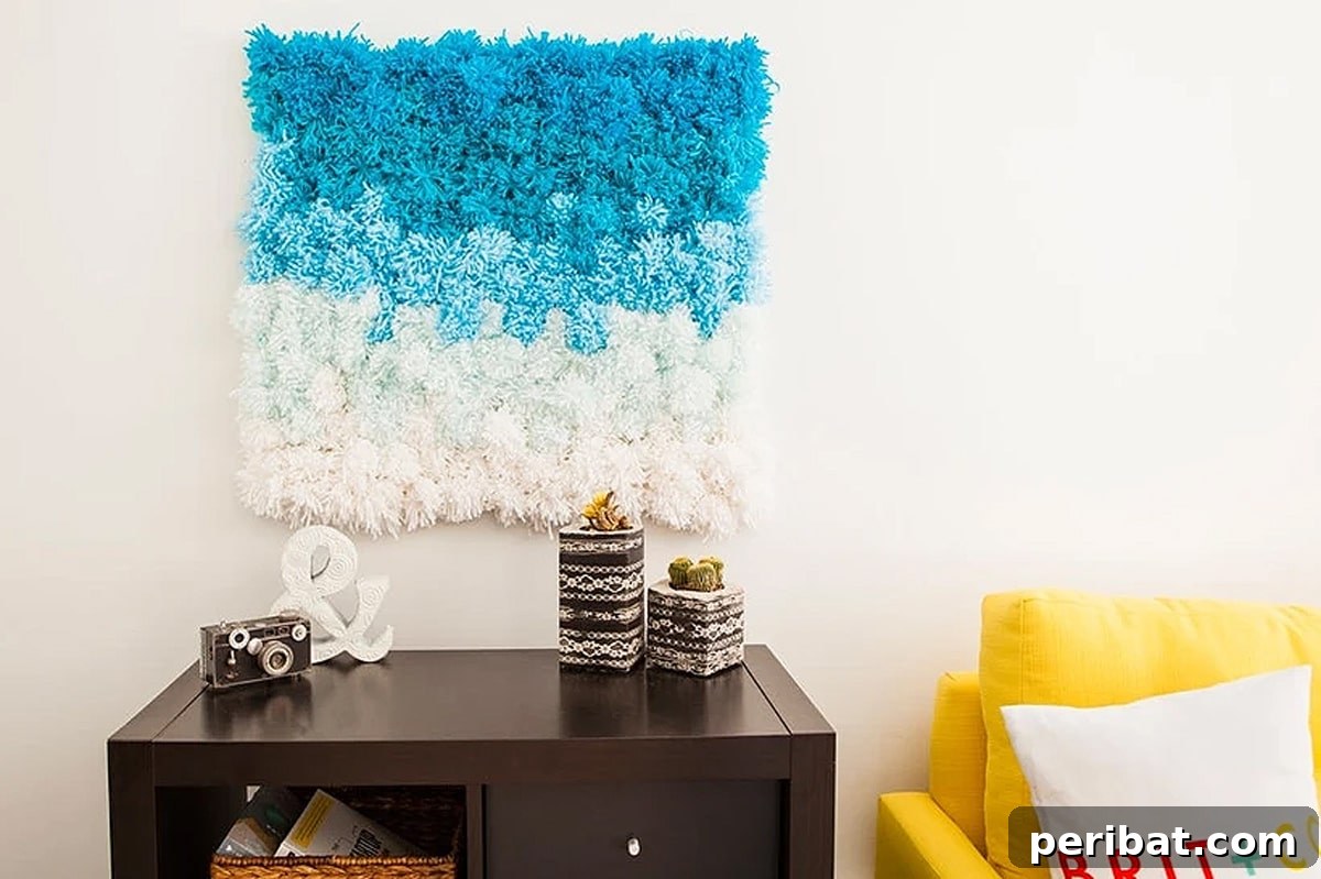 A versatile, multicolored pom pom creation displayed as a fluffy rug on a wooden floor.